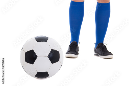legs of soccer player in blue kneesocks with ball isolated on wh