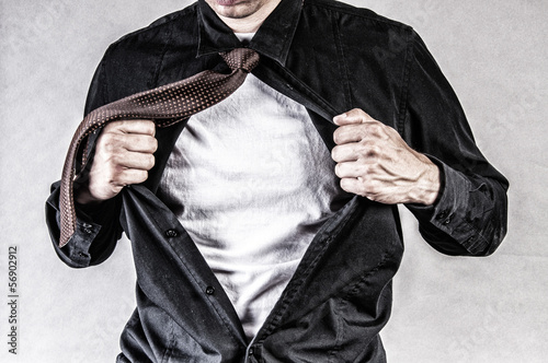 young businessman pulls shirt