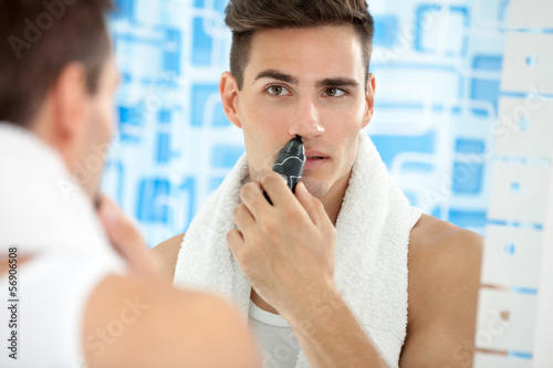 man remove hair from his nose photo