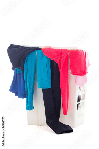 dirty clothes in a laundry basket on white background
