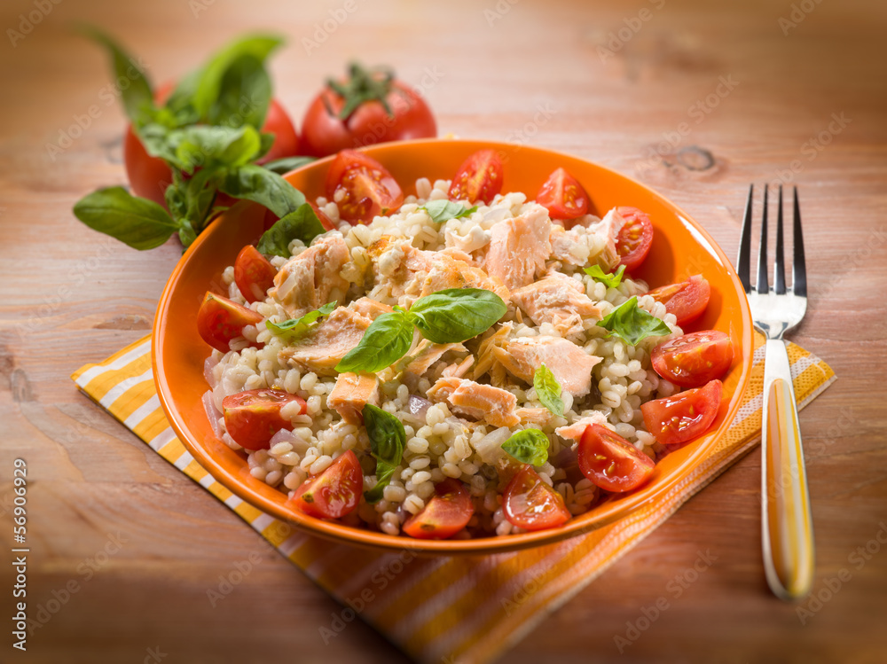 barley risotto with fresh salmon and tomatoes, selective focus