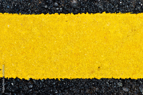 Closeup rough yellow paint on asphalt road