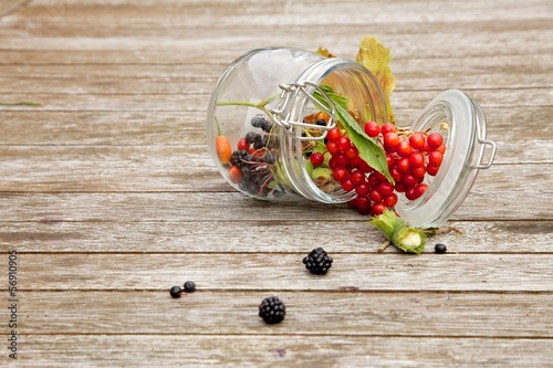 Fruits of the forest on woody background photo