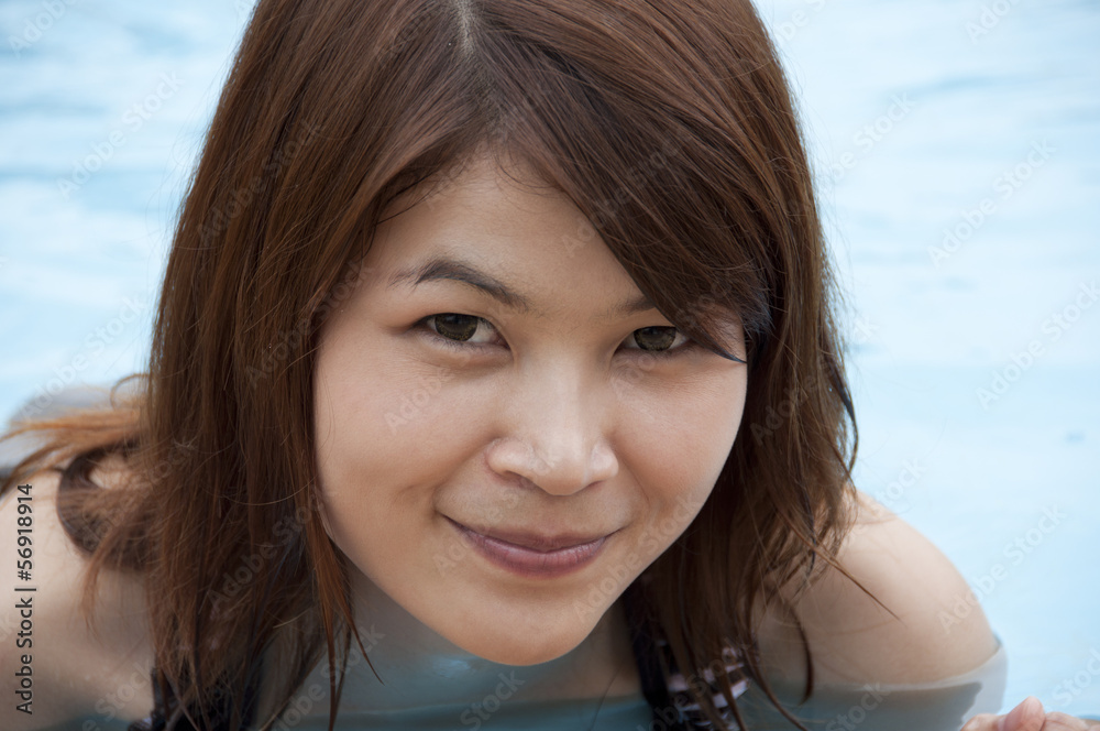Beautiful Asian woman in swimming pool. Beautiful Asian woman in swimming pool.