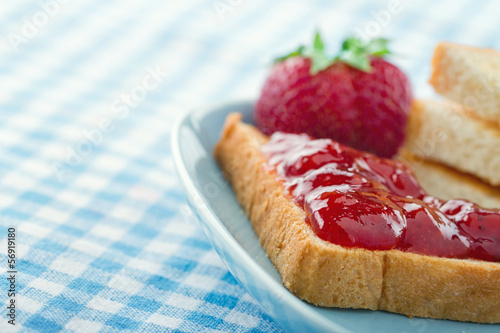 Bread with red strawberry jam