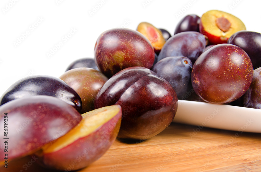 Fototapeta premium fresh plums on wooden table