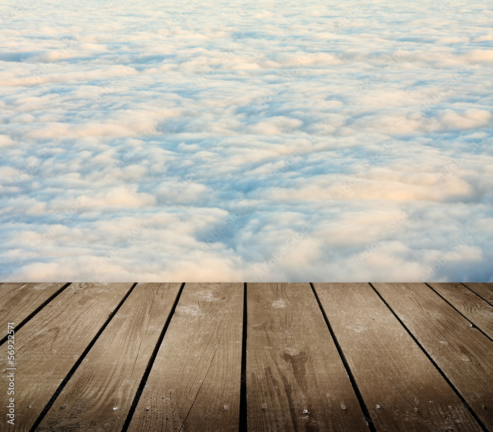 empty wooden deck table with clouds.