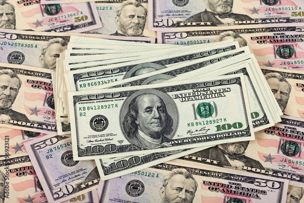 Fototapeta premium Stack of one hundred dollar bills on money background