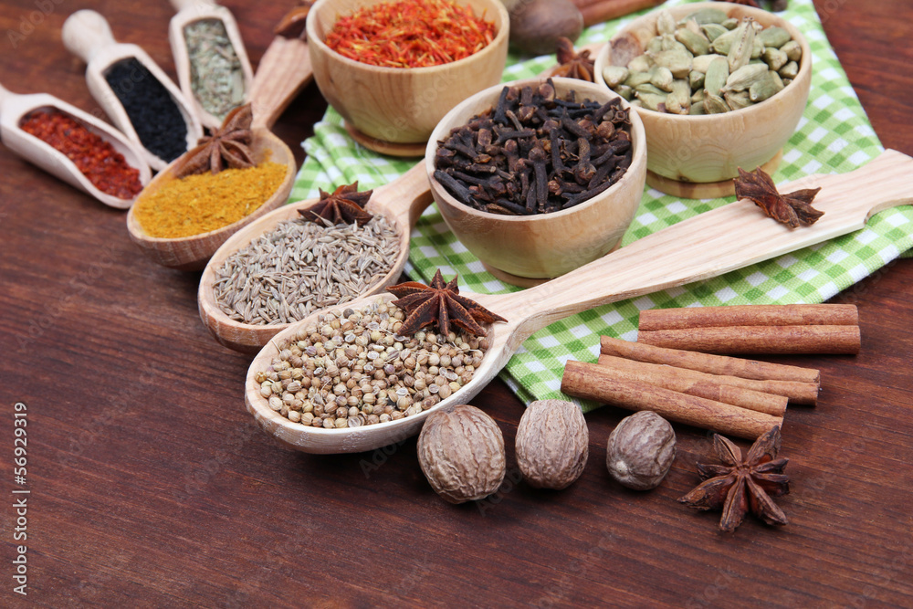 Various spices and herbs on wooden background Various spices and herbs on wooden background