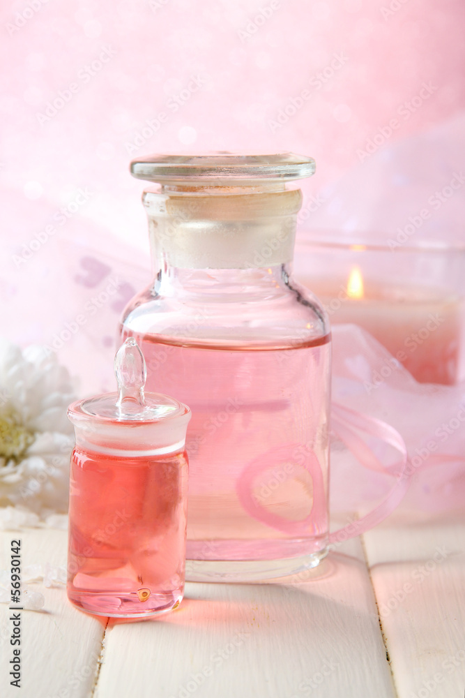 Glass bottle with color essence, on wooden background Glass bottle with color essence, on wooden background