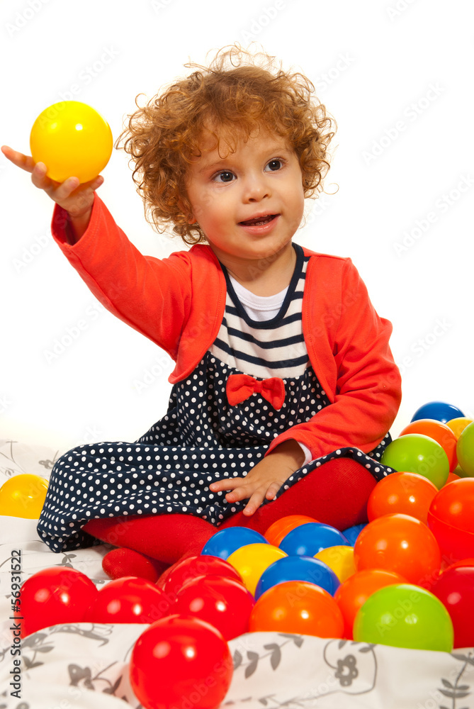 Obraz premium Toddler girl playing with balls