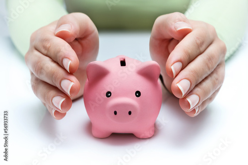 protect your savings - with hands and piggy bank