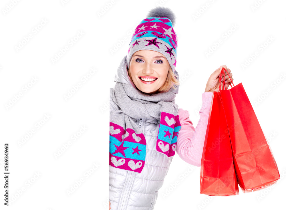 woman with gifts to the new year looks out from the white blank