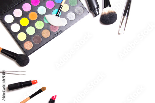 make-up brushes, colorful eyeshadow palette, tweezers and lipsti photo