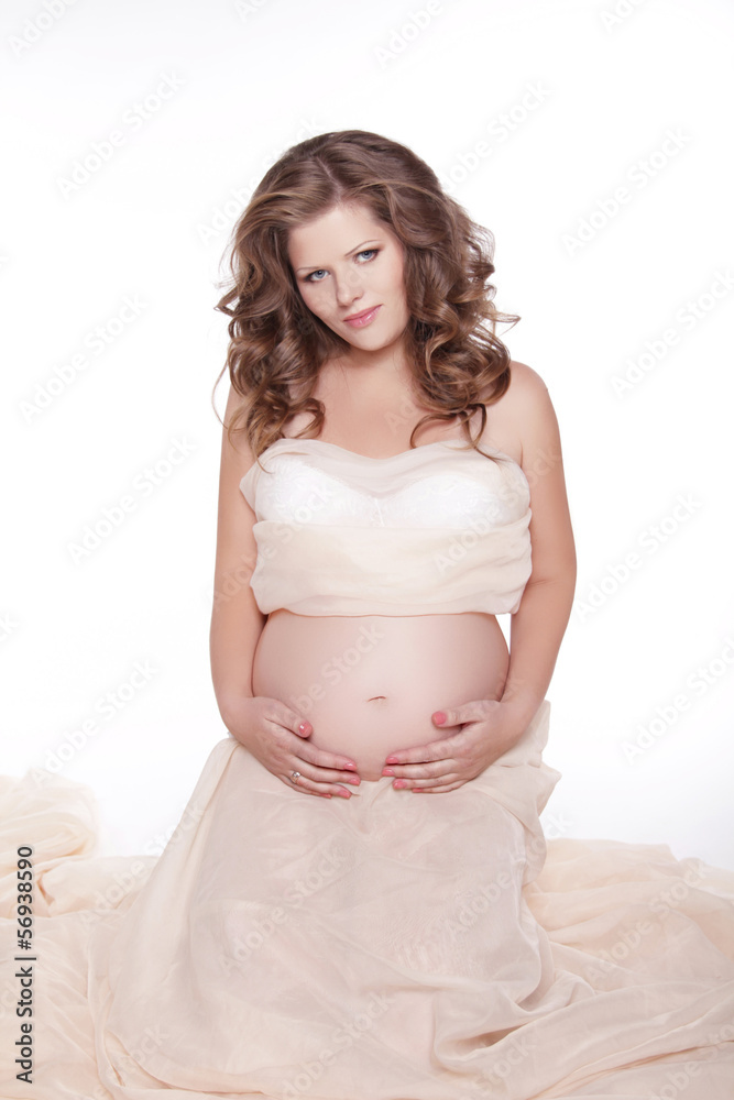 Beautiful woman expecting a baby and stroking her belly isolated Beautiful woman expecting a baby and stroking her belly isolated