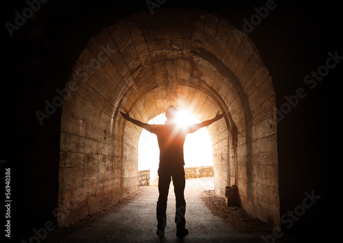 Fototapeta Man stands inside of old dark tunnel