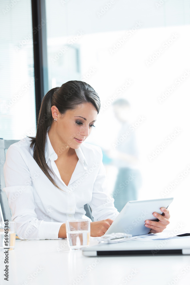 Businesswoman working on her digital tablet Businesswoman working on her digital tablet
