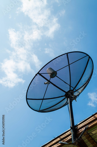 black antenna communication satellite dish over sunny blue sky
