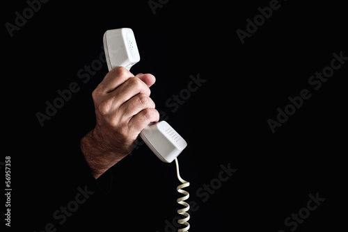 Hand holding telephone receiver