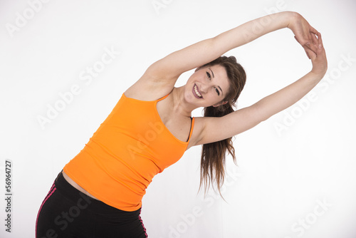 Young lady doing sport exercises, stretching and warming