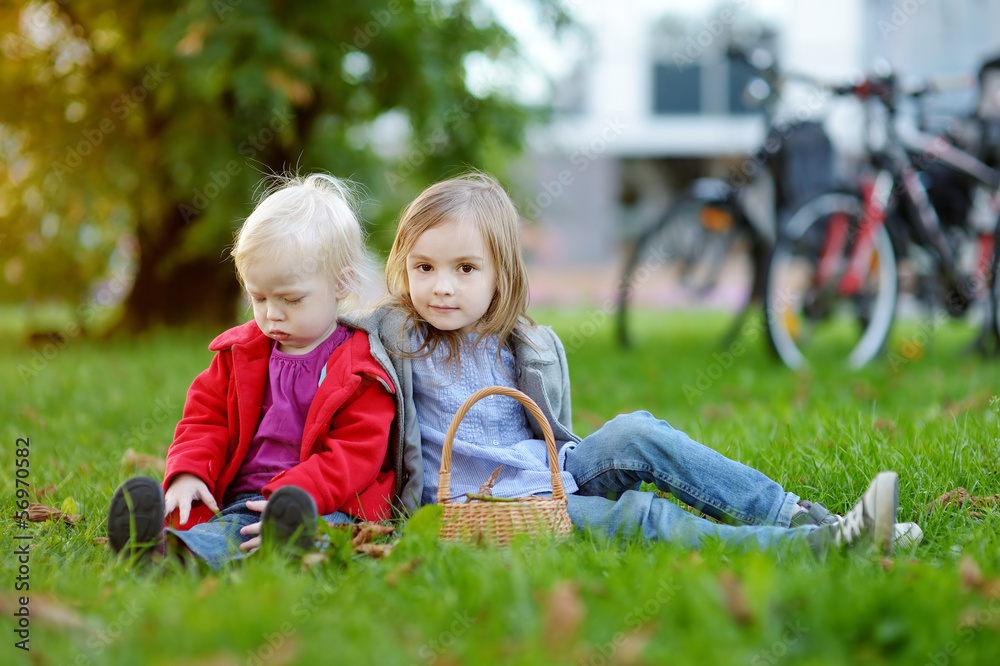 Two little sisters playing outside Two little sisters playing outside