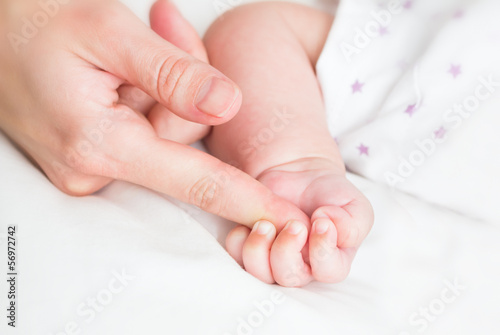 Baby holding the mother's finger