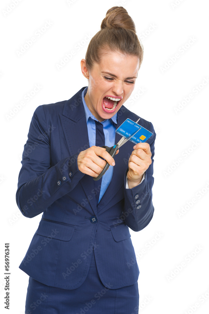 Angry business woman cutting credit card with scissors Angry business woman cutting credit card with scissors