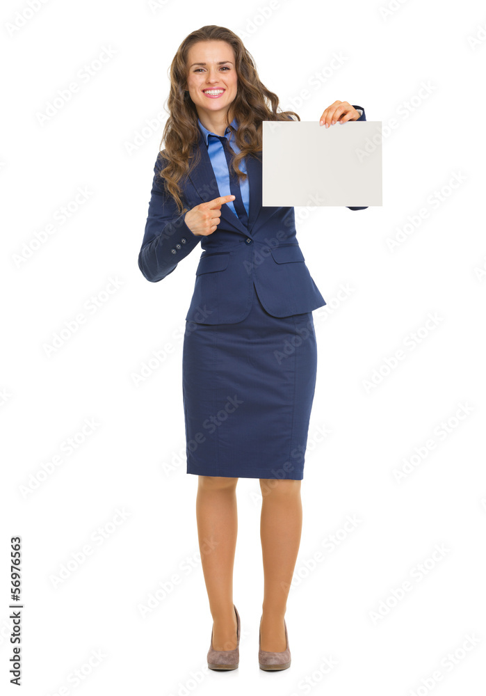 Full length portrait of smiling business woman pointing on blank Full length portrait of smiling business woman pointing on blank