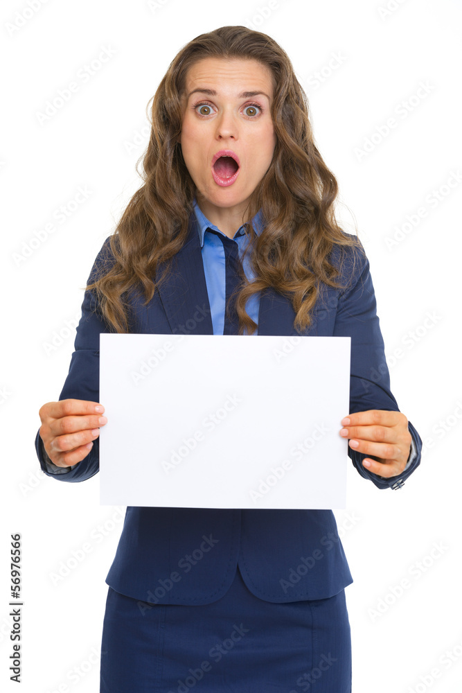 Surprised business woman showing blank paper sheet Surprised business woman showing blank paper sheet