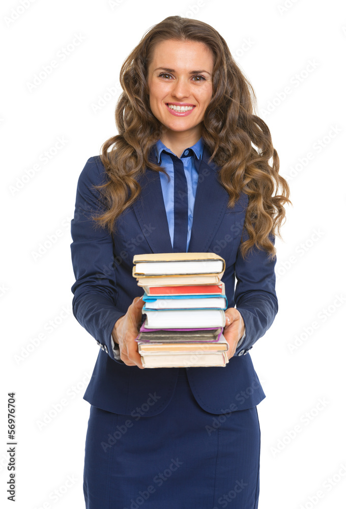Smiling business woman giving stack of books Smiling business woman giving stack of books