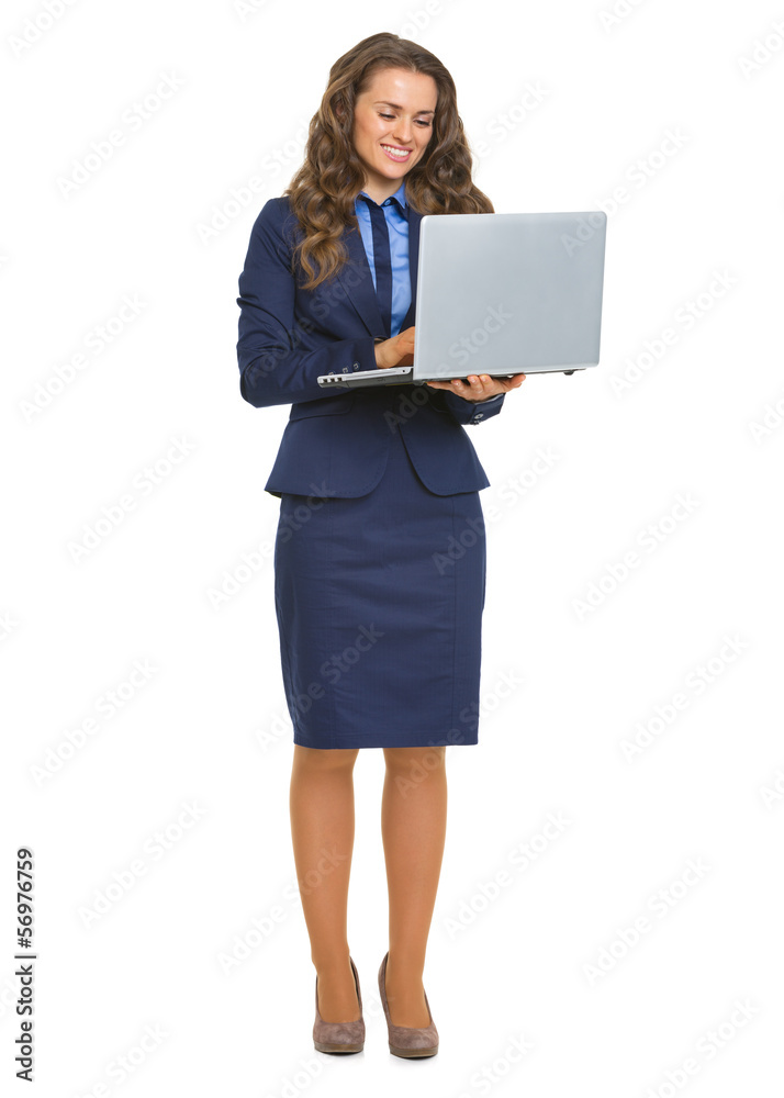 Full length portrait of smiling business woman with laptop Full length portrait of smiling business woman with laptop