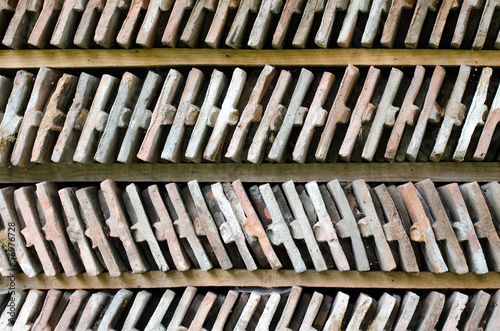  Close up on two rows of arranged bricks on a wood shelf. 