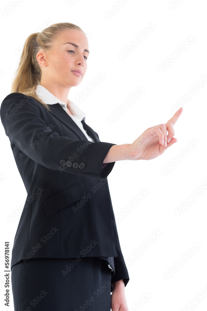 Low angle view of young businesswoman pointing upwards Low angle view of young businesswoman pointing upwards