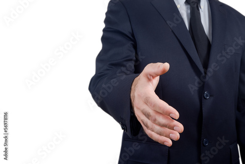 businessman holds out his hand to make a deal