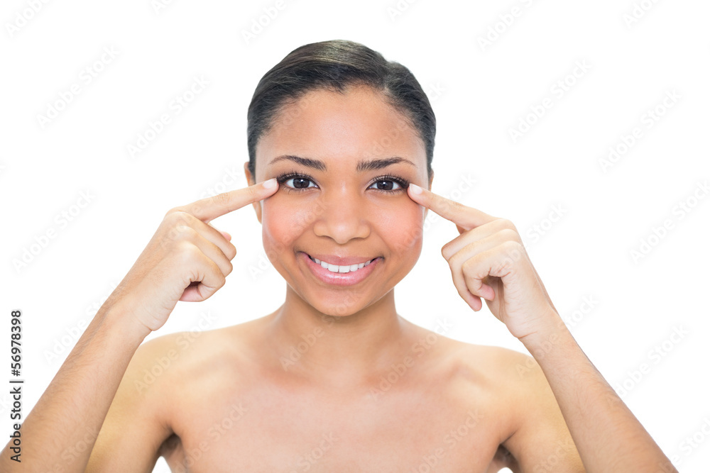 Pleased young dark haired model pointing her eyes with her finge Pleased young dark haired model pointing her eyes with her finge