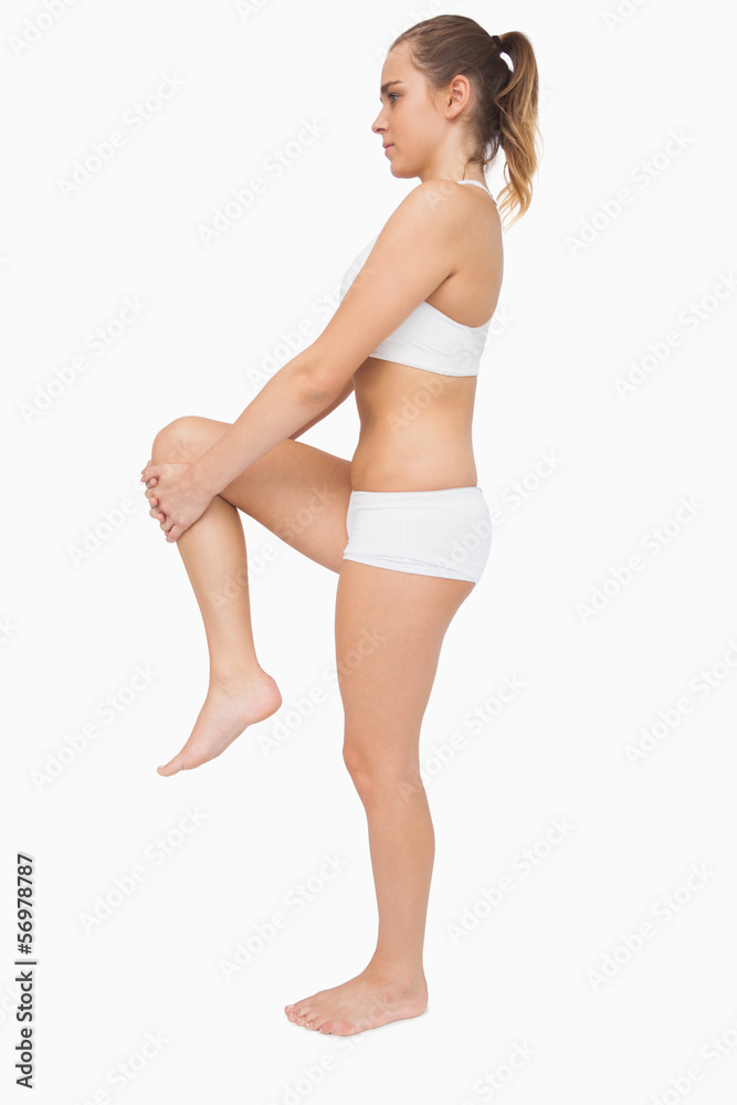 Cute ponytailed woman stretching her legs Cute ponytailed woman stretching her legs