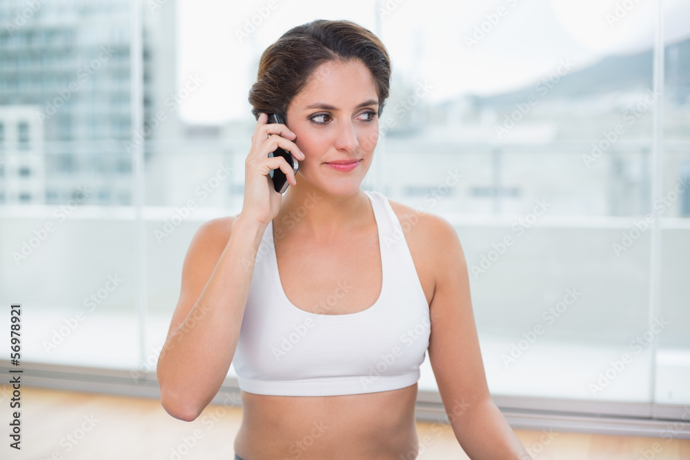 Sporty pleased brunette phoning