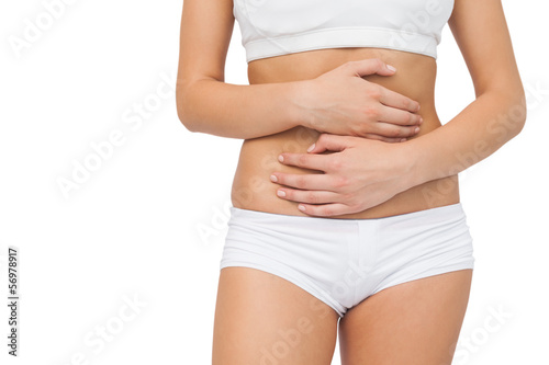 Young woman touching her belly with her hands