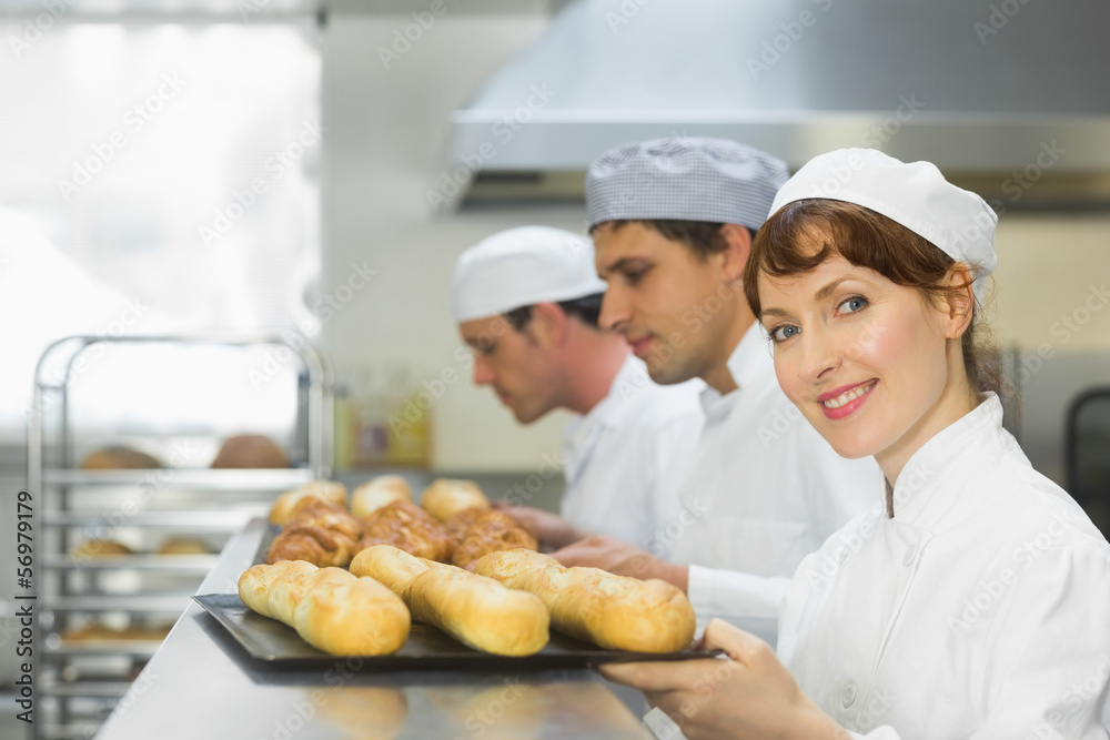 Happy female baker smiling at the camera Happy female baker smiling at the camera
