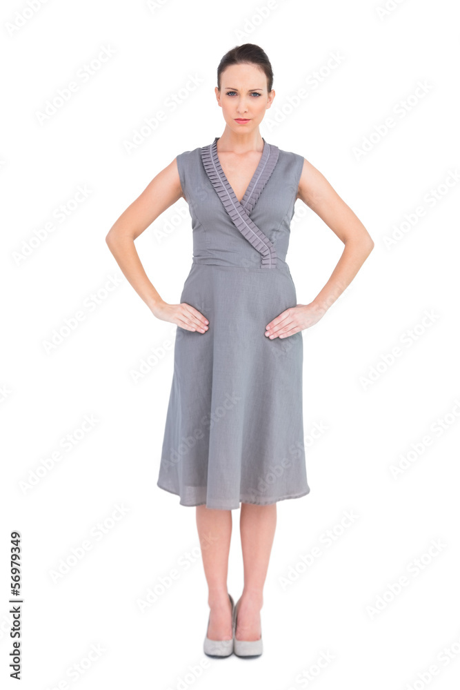 Frowning elegant brunette in classy dress posing Frowning elegant brunette in classy dress posing