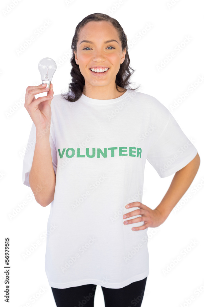 Thoughtful volunteer woman holding a light bulb Thoughtful volunteer woman holding a light bulb