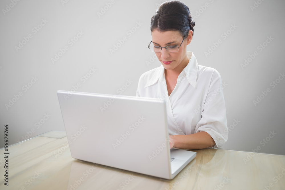 Focused businesswoman with classy glasses posing Focused businesswoman with classy glasses posing