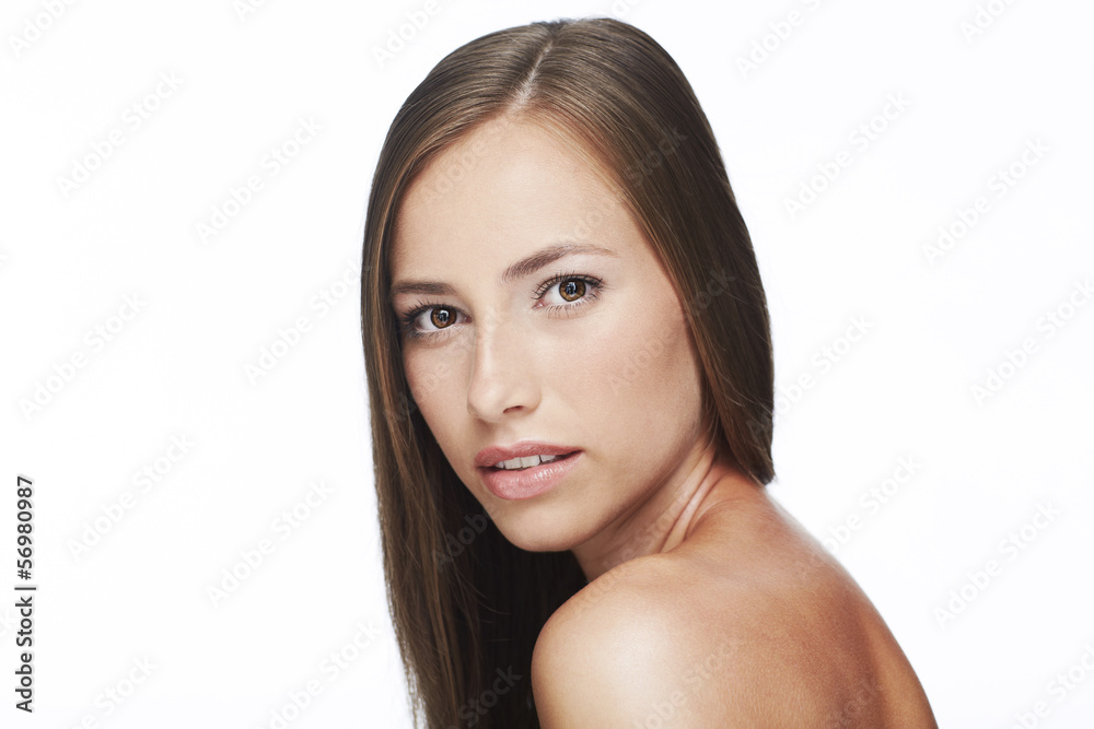 Portrait of young woman against white background