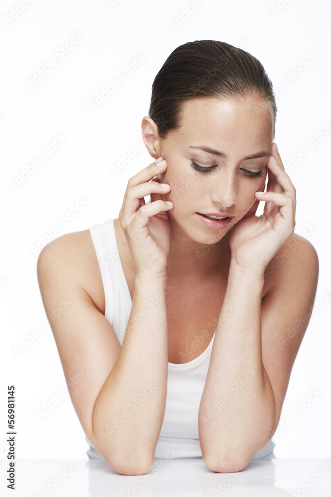 Young woman looking down against white background