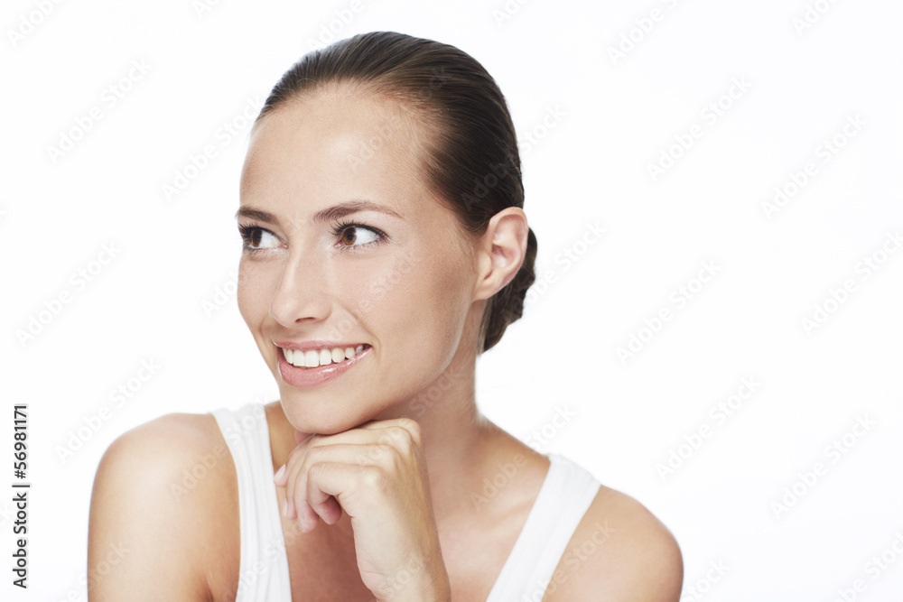 Young woman looking away and smiling in studio Young woman looking away and smiling in studio