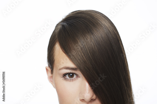 Portrait of young woman with hair covering face