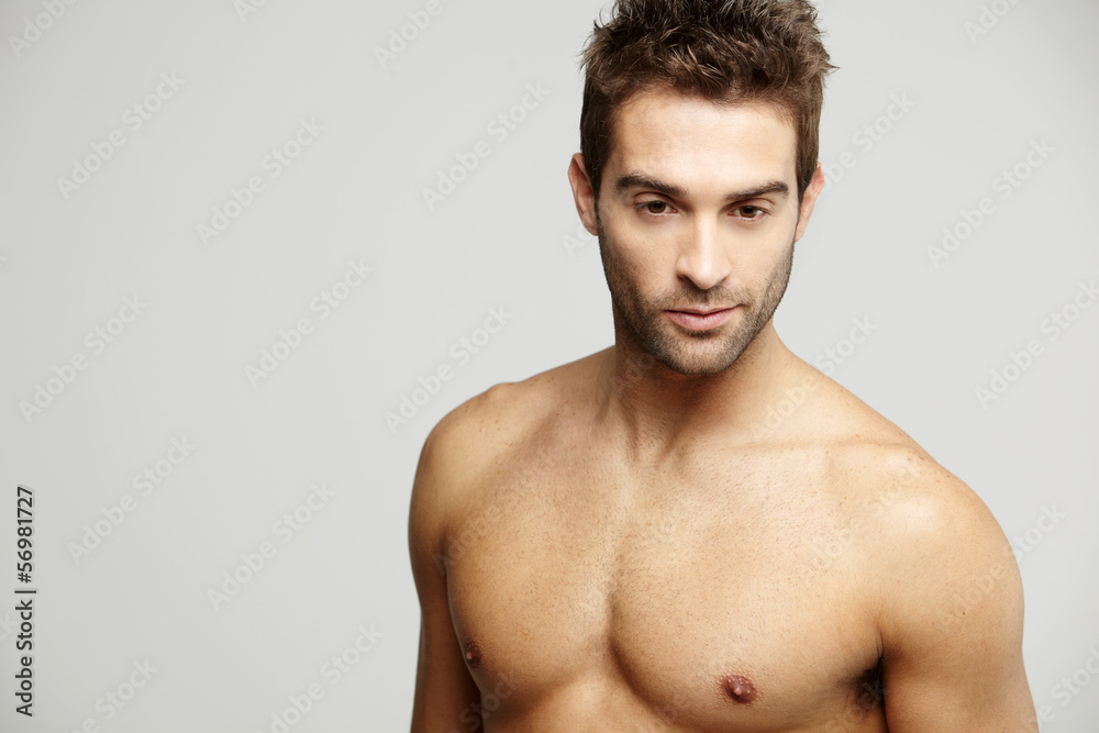 Fototapeta premium Mid adult man looking down, studio shot