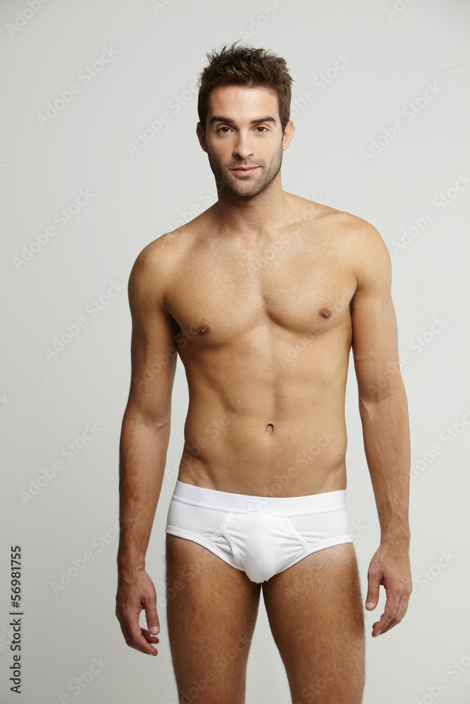 Portrait of mid adult man in briefs, studio shot Portrait of mid adult man in briefs, studio shot