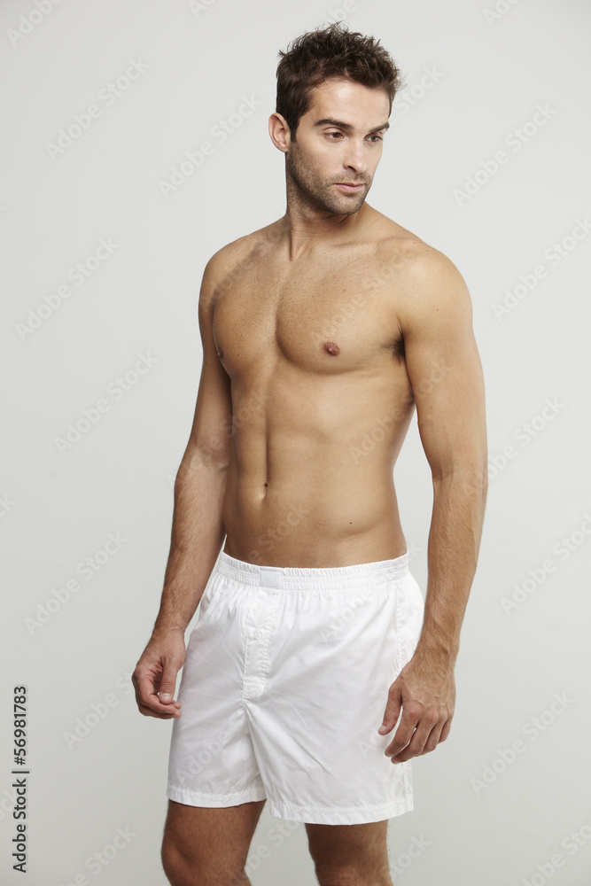 Mid adult man in boxer shorts, studio