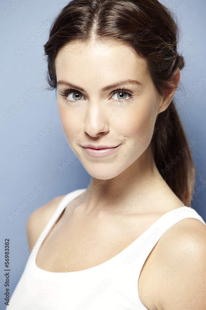 Portrait of a young woman on a blue background Portrait of a young woman on a blue background